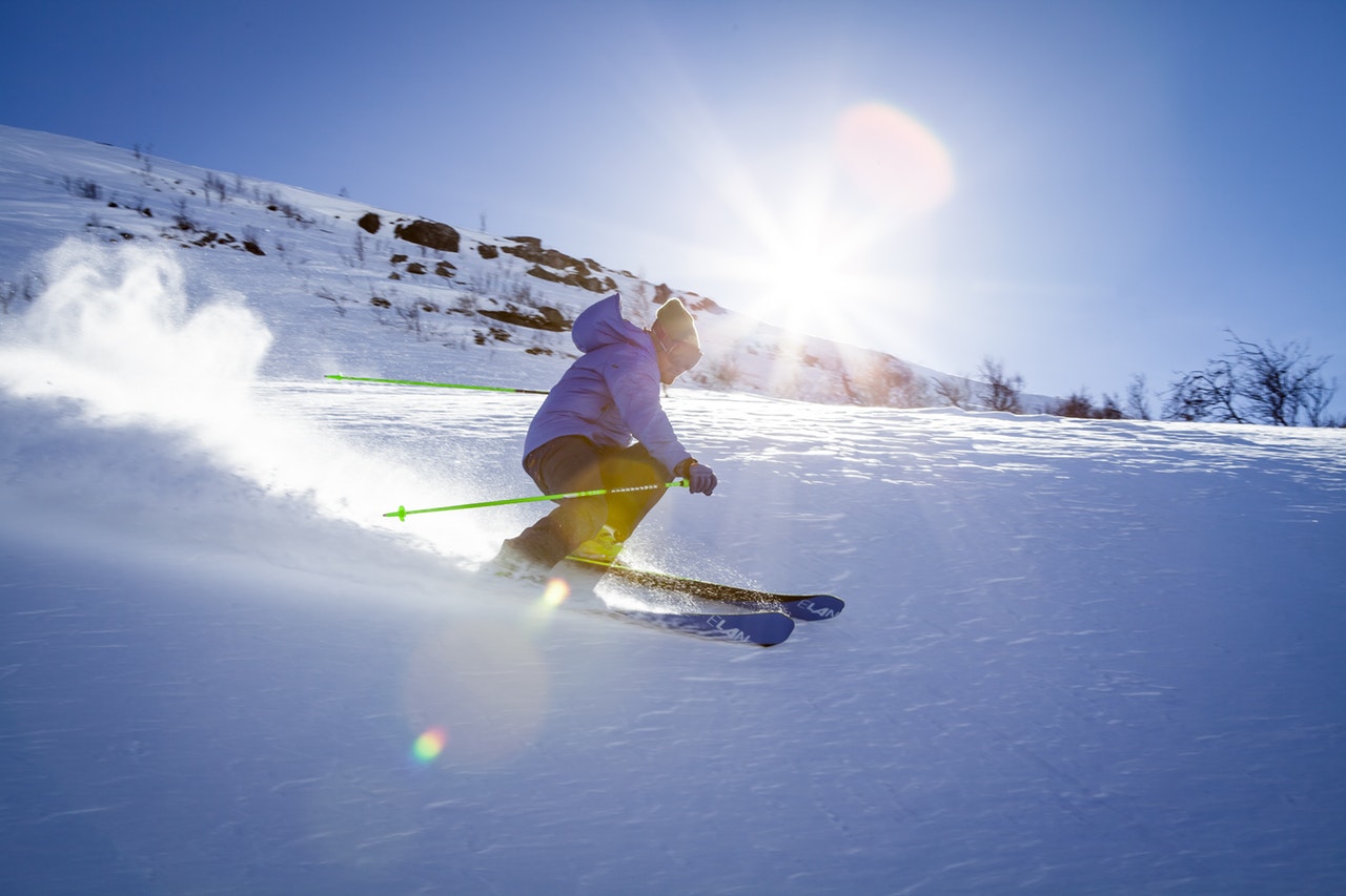 man on skies with the sun in the background