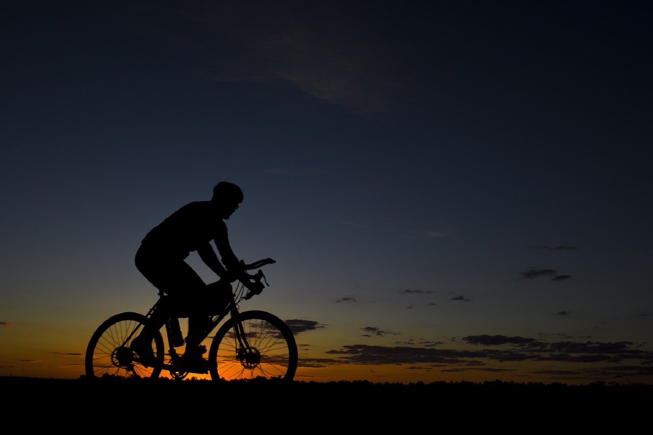 silhouette of cyclist on a trail during sunset
