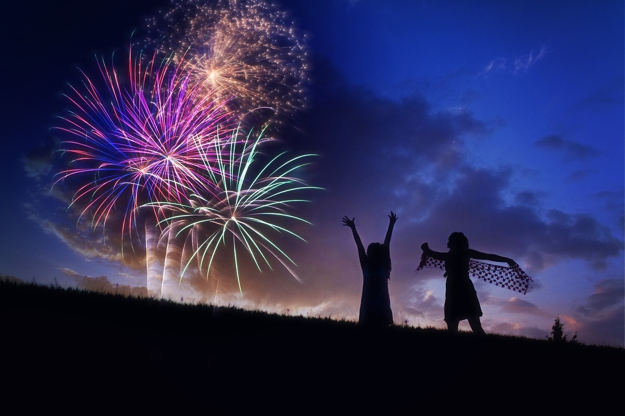 Two individuals enjoying the Park City 4th of July fireworks show