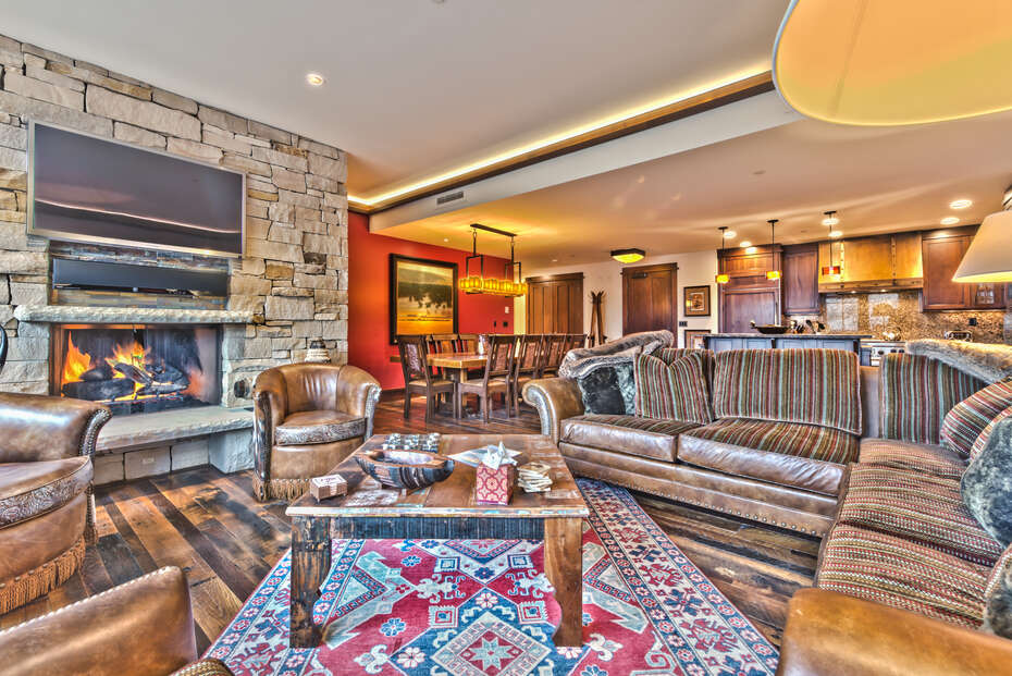 The Kitchen, Dining Area, and Living Room with Fireplace in One of Our Park City Utah Luxury Rentals.