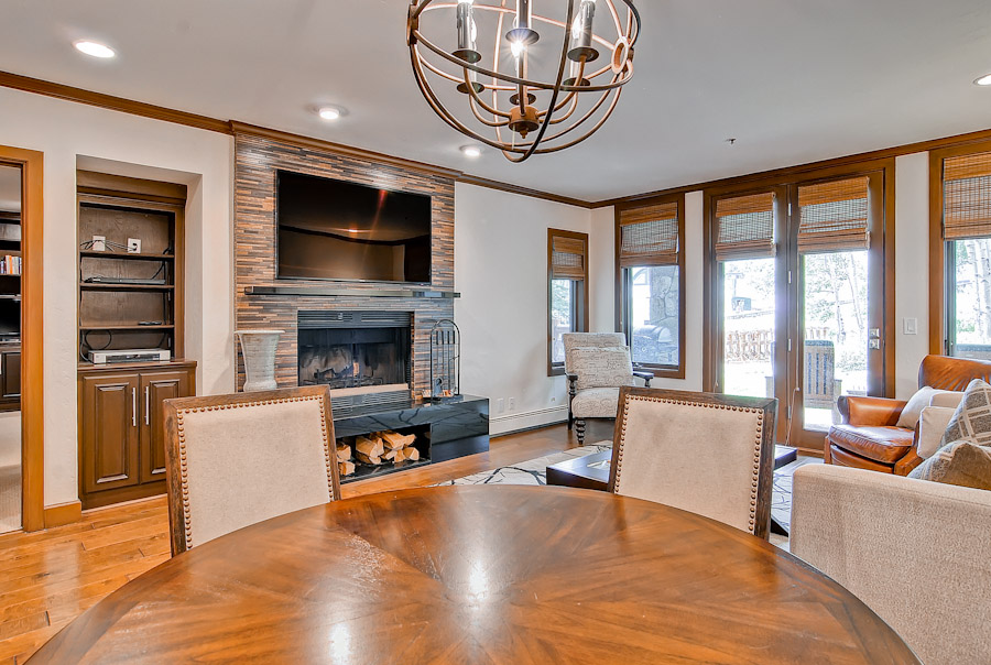 Dining Set and Living Room with Fireplace in Our One Bedroom Deer Valley Condo Rentals.