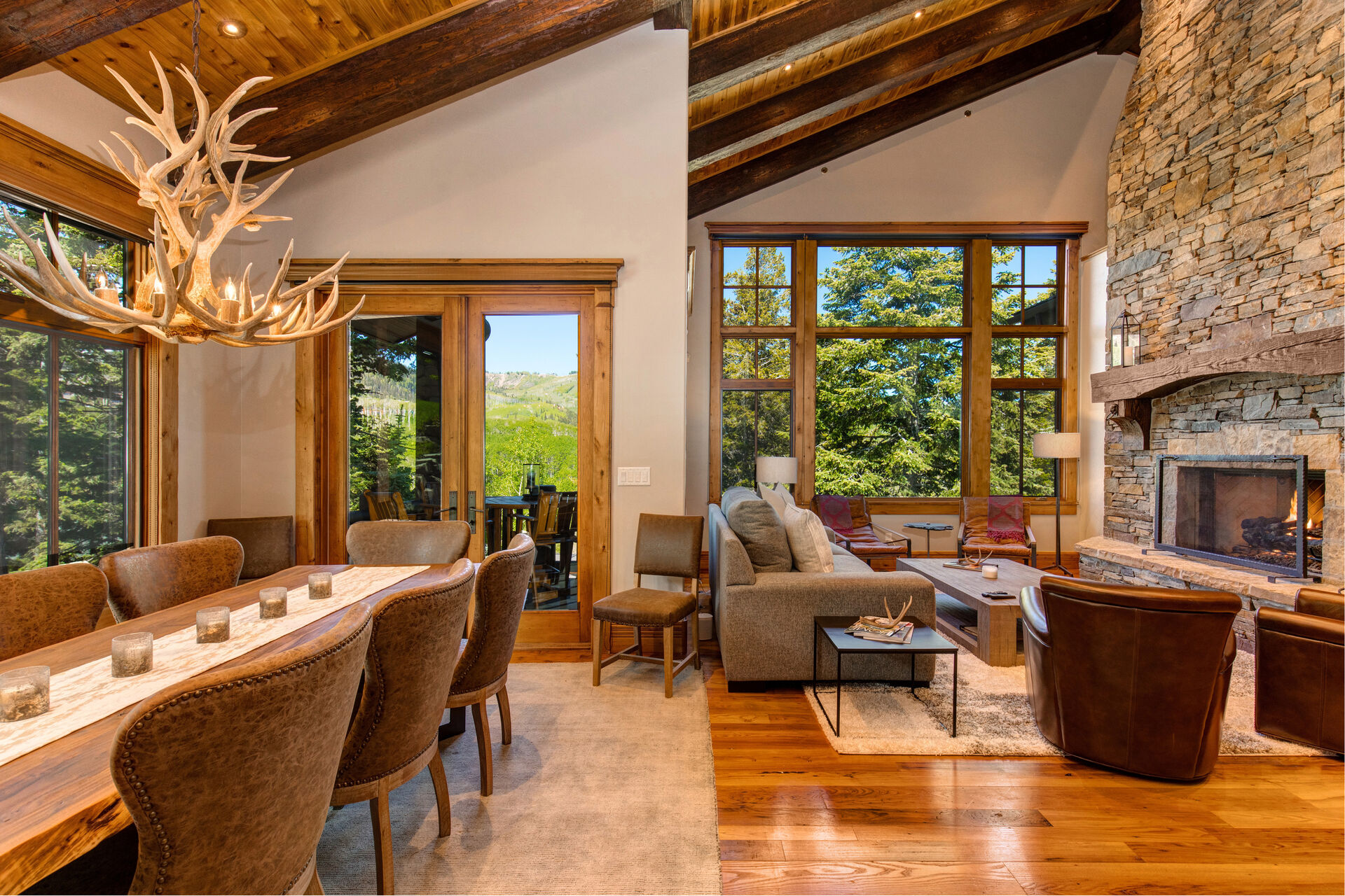 Dining Set and Living Room with Fireplace and Deck Access in Our Rental Homes in Park City, Utah.